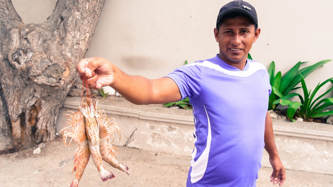 ecuador salinas man selling shrimps